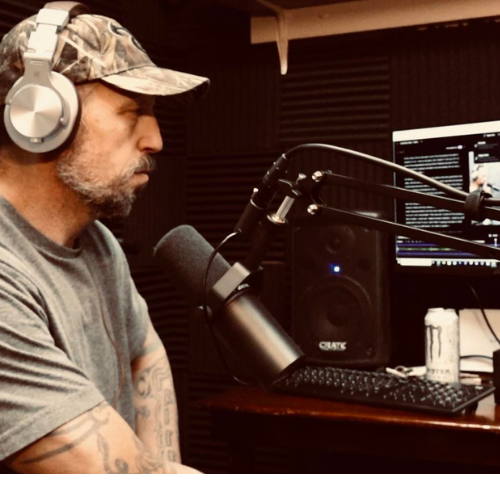 Shaun McClure at the microphone in a radio studio